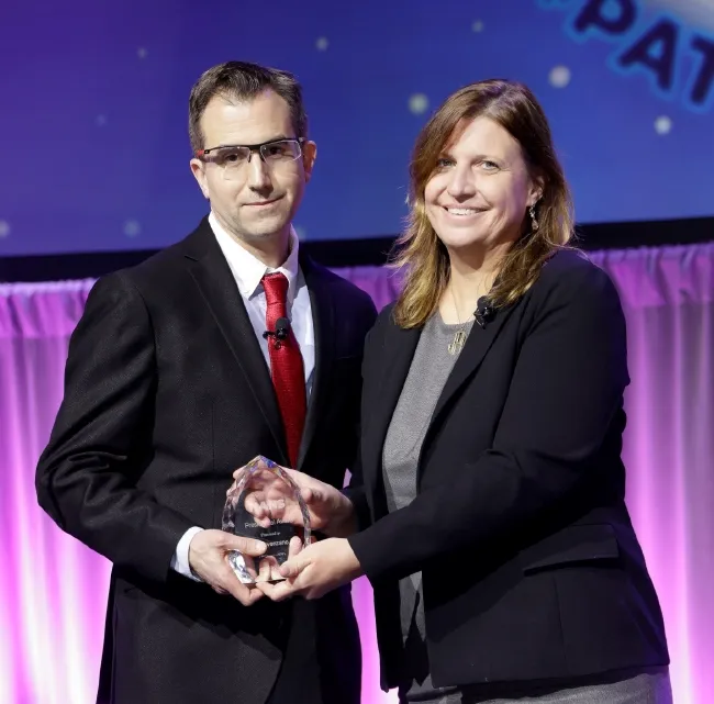 Dr. David Provenzano receiving an award on stage